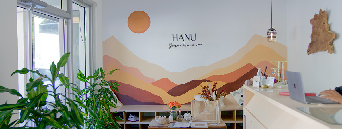 The HANU mountain mural in the lobby — orange sun over layered mountains